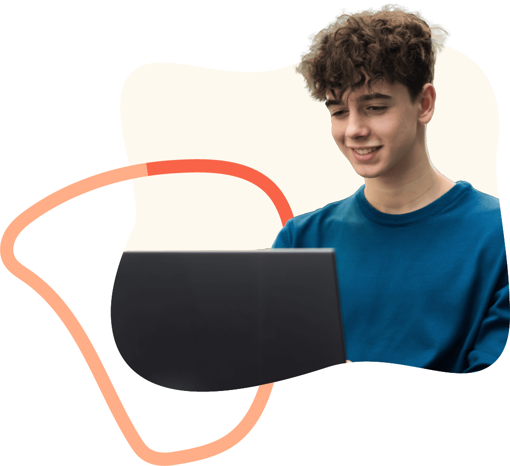 Teenage boy looking at laptop and smiling
