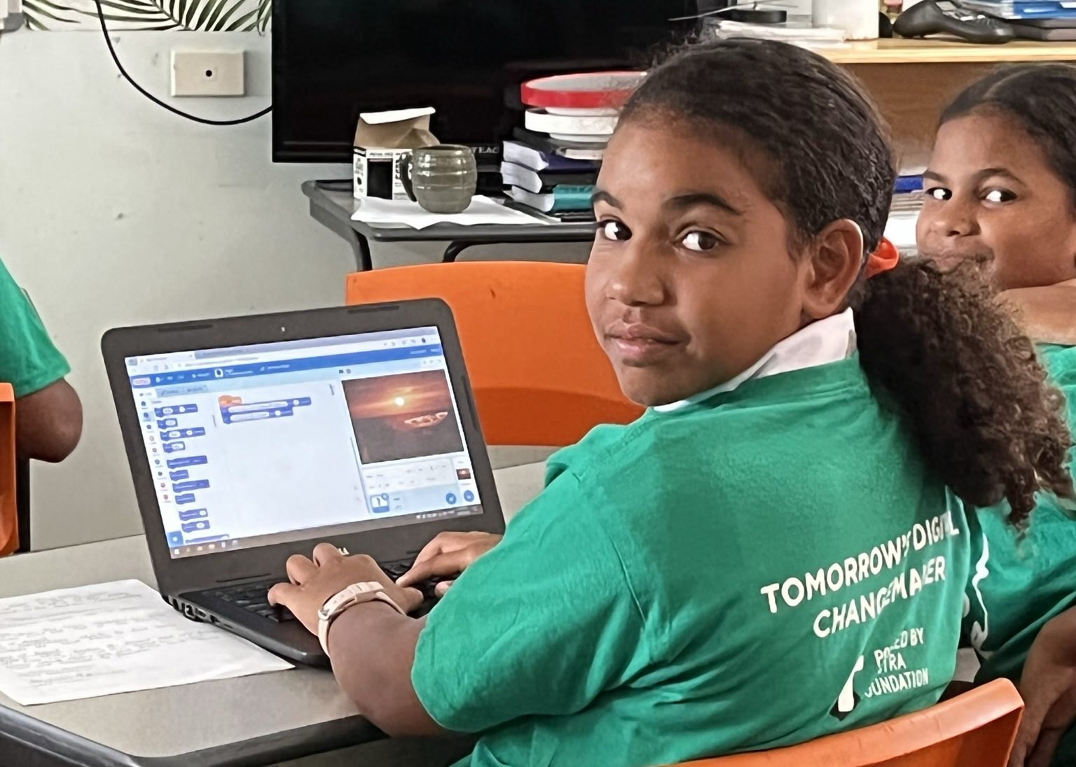 Two young girls sitting at a desk and taking part in the code club australia skill development program